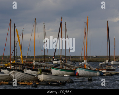 Sailing boats moored off Blakeny on a stormy day with Blakeny Point in the background.  Blakeney, Norfolk. UK. Stock Photo