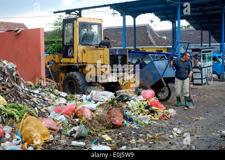 local man working amongst a huge pile of fetid refuse on a public dump in malang java indonesia Stock Photo