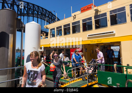 Sydney Australia,Sydney Ferries,Harbour Bridge,harbor,ferry,boat,riders,passenger passengers rider riders,getting off,disembarking,man men male,woman Stock Photo