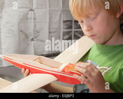 7-year old building wooden model airplane Stock Photo