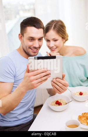 smiling couple with taking picture with tablet pc Stock Photo