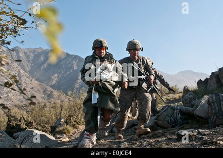 NURISTAN PROVINCE, Afghanistan – In the middle of an eight-hour firefight against insurgents, U.S. Army Spc. Brit B. Jacobs ( Stock Photo