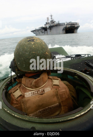 U.S. Marine Lance Cpl. Brock A. Goldbeck, a crewman with Company A, 2nd Assault Amphibian Battalion, attached to Special-Purpos Stock Photo