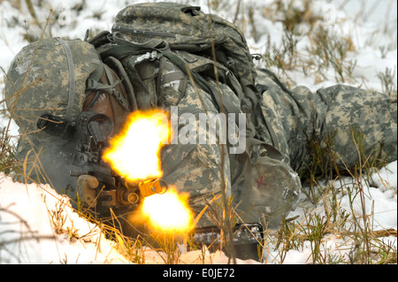 U.S. Army Spc. Ladarion Banks, assigned to Killer Troop, 3rd Squadron, 2nd Cavalry Regiment, fires his M249 Squad Automatic Wea Stock Photo