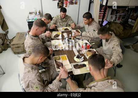 DELROM, Afghanistan – Marines serving with 3rd Battalion, 7th Marine Regiment’s Security Force Advisor Team pray before the Stock Photo