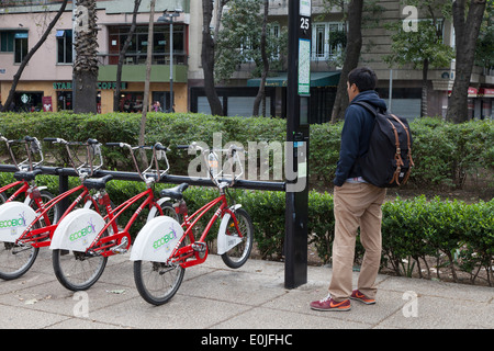 Man renting a bike from Ecobici along Paseo De La Reforma on Car free Sunday Stock Photo
