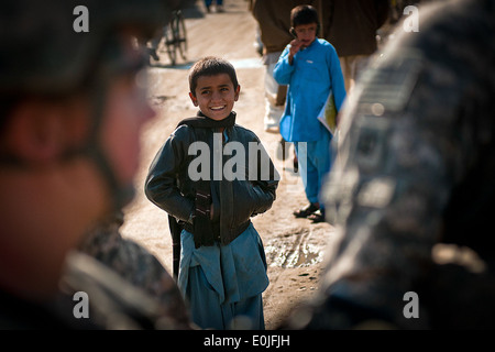 NANGARHAR PROVINCE, Afghanistan – An Afghan boy smiles and laughs as U.S. Army Soldiers assigned to Company A, 1st Special Tr Stock Photo