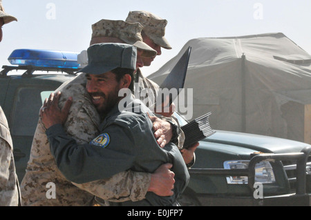 A U.S Marine Corps drill instructor congratulates a graduate of Afghan National Police Class 2010-02 after the class' graduatio Stock Photo