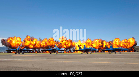 A fiery wall engulfs the clear Hawaiian sky behind the U.S. Navy’s Flight Demonstration Squadron, the Blue Angels, during a M Stock Photo