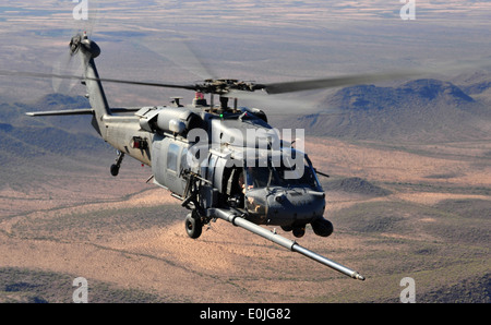 U.S. Air Force HH-60 Pave Hawk helicopter assigned to the 66th Rescue Squadron Nellis AFB, Nev., maneuver behind a HC-130 to pe Stock Photo
