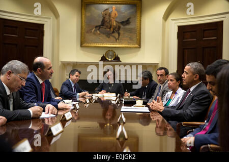 US President Barack Obama drops by National Security Advisor Susan E. Rice's meeting with Syrian Opposition Coalition President Ahmad Jarba, second from left, in the Roosevelt Room of the White House May 13, 2014 in Washington, DC. Stock Photo