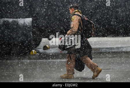 A C-130J Super Hercules pilot prepares to load the plane at Bagram Air Field, Afghanistan, Feb. 6, 2014. Snowfall began at appr Stock Photo