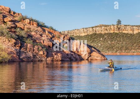 senior male paddling a decked expedition canoe on Horsetooth Reservoir near Fort Collins, Colorado Stock Photo