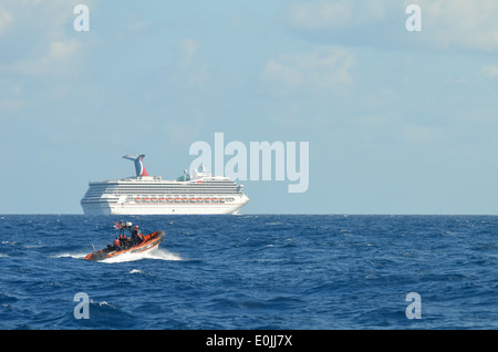 The Coast Guard Cutter Vigorous escorts the Carnival cruise ship Triumph to Mobile, Ala., after an engine room fire a few days Stock Photo