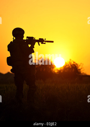 A MARSOC Marine pulls security near a poppy field in Peyo as Afghan National Army Soldiers and Marine Special Operation Command Stock Photo
