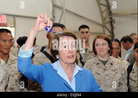 House Democratic Leader, Nancy Pelosi (D-Calif.) displays a congressional coin to troops on Camp Leatherneck during a Mother's Stock Photo