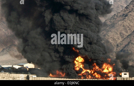 NURISTAN PROVINCE, Afghanistan – A fire rages Dec. 28 on Forward Operating Base Kalagush, Nuristan Province, Afghanistan. The Stock Photo