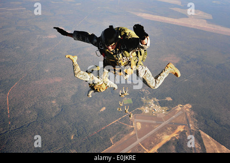 U.S. Army Special Forces soldiers practice high altitude low opening (H.A.L.O.) jumps out of a Royal Air Force C-130K during Em Stock Photo