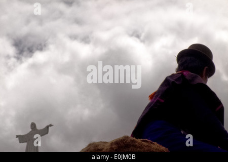 A Guambiano man sits on the top of a Chiva bus during the traditional Indian market in Silvia, Colombia. Stock Photo