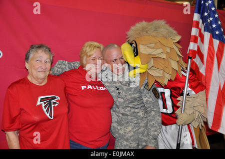 Navy Petty Officer Jeff Howard surprises his mother and grandmother at a Falcons Preseason Game at the Georgia Dome. Petty Off Stock Photo