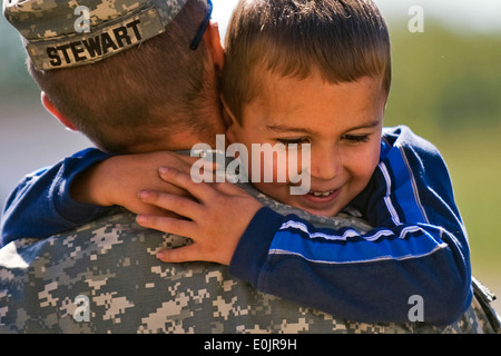 Staff Sgt. Patrick Stewart, infantryman from Terra Haute, Ind., holds his fiance's son at the 3-19th Agricultural Development T Stock Photo