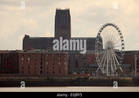 The cathedral, dock buildings and giant ferris wheel in Liverpool, United Kingdom. Stock Photo