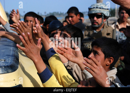 An Iraqi army soldier with the Emergency Unit secures the area while stopped during a joint neighborhood patrol with U.S. Army Soldiers of 2nd Platoon, Charlie Troop, 1st Squadron, 10th Calvary Regiment, 2nd Brigade Combat Team, 4th Infantry Division in I Stock Photo