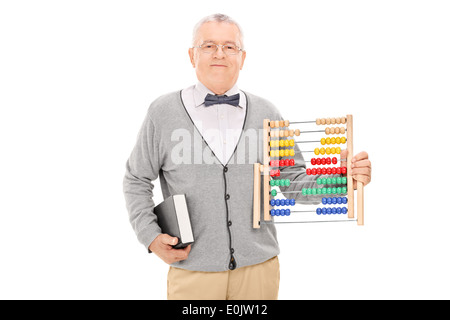 Mature teacher holding a book and an abacus Stock Photo