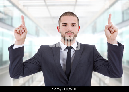 businessman in a suit pointing with his fingers, at the office Stock Photo