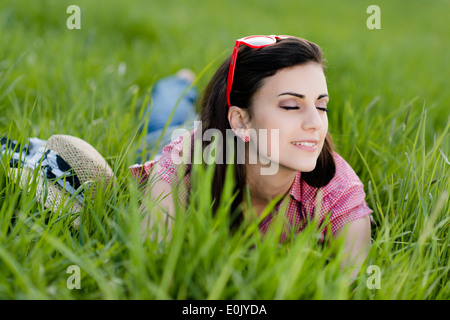 Young woman relaxing on the spring meadow, (Model release) Stock Photo