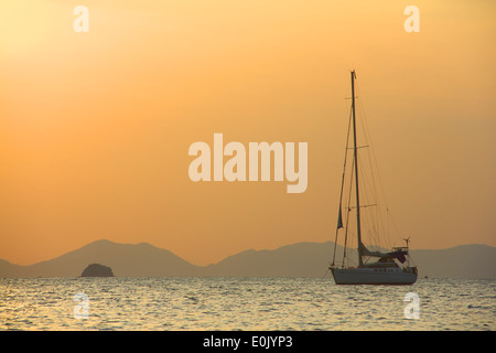 Sailing yaht in open sea on beautiful sunset sky background Stock Photo ...