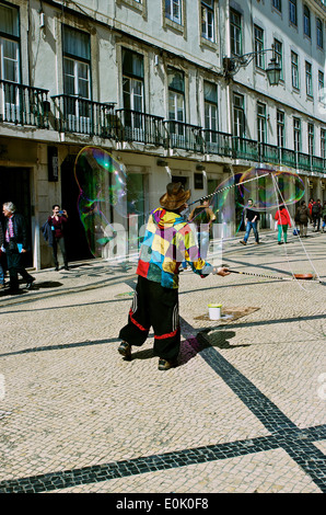 Street entertainer blowing giant soap bubbles in Rua Augusta Lisbon Portugal western Europe Stock Photo