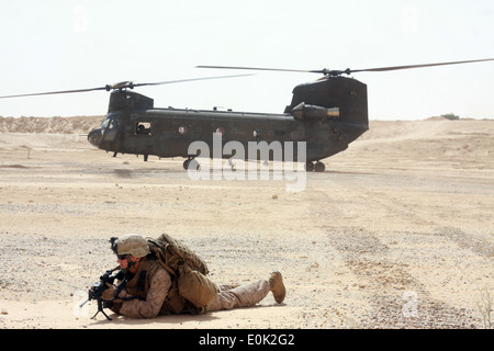 A Marine with 4th platoon, 2d Battalion, 1st Marines, quick reaction force team, lays in the prone position and provides securi Stock Photo