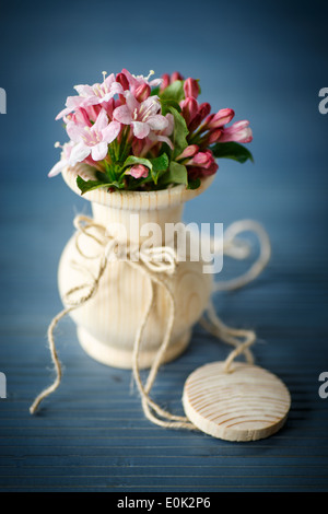 Weigela blooming beautiful wood vase on the table Stock Photo Alamy