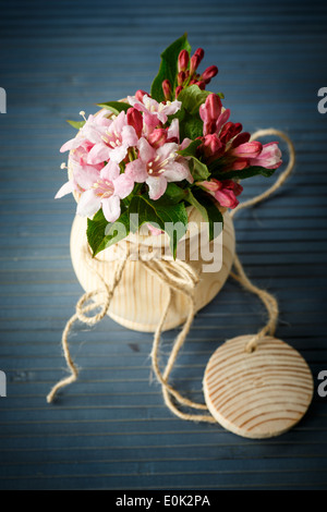 Weigela blooming beautiful wood vase on the table Stock Photo Alamy