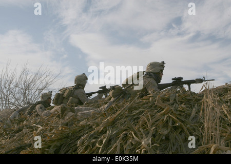 Marines with Bravo Company, 1st Battalion, 6th Marine Regiment take cover behind a berm after receiving small-arms fire, Feb. 1 Stock Photo