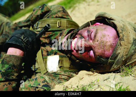 Pvt. Nicholas Heffernan, a Marine with Platoon 3028, Mike Company, 3rd Recruit Training Battalion, back crawls through the sand Stock Photo