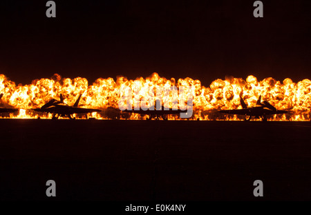 Flames explode behind the Navy Blue Angels' F/A-18 Hornets during the night portion of the 2012 Marine Corps Air Station Mirama Stock Photo