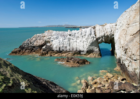 Bwa Gwyn white natural rock sea arch on coast, near Rhoscolyn, Anglesey, North Wales, UK Stock Photo