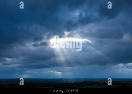 Rays of the sun break through cloudy stormy sky in inclement weather, UK Stock Photo