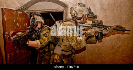 An Afghan and coalition security force conduct room searches in which they detained eight suspected insurgents during an operat Stock Photo
