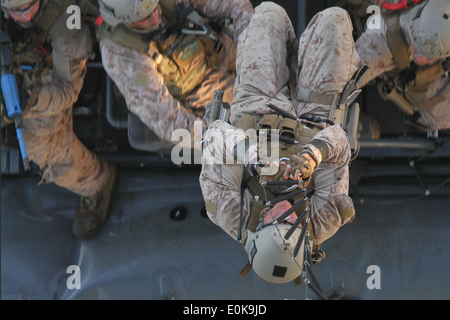 A Marine with the 11th Marine Expeditionary Unit's maritime raid force uses a rope ladder to climb the oil platform Hogan durin Stock Photo