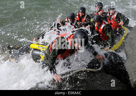 Students assigned to Basic Underwater Demolition/SEAL class 282 participate in Rock Portage at Coronado Island. Rock Portage is Stock Photo