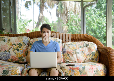 Young man using a portable computer at home Stock Photo