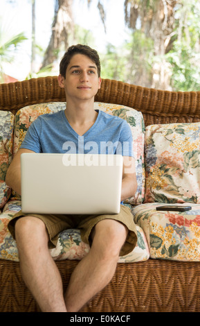 Young man using a portable computer at home Stock Photo