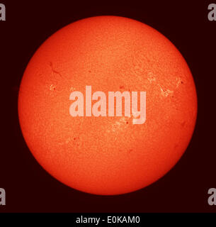 London, UK. 15th May, 2014. Telescope image of our nearest star, the Sun, photographed through a solar Hydrogen alpha filter showing surface activity including surface granulation, filaments, lighter areas of plage and nine designated sunspots including AR2063 (at 10 o’clock on disc) which is crackling with C Class solar flares. These smaller flares have almost no effect on Earth and do not cause appreciable geomagnetic disturbance. Credit:  Malcolm Park editorial/Alamy Live News Stock Photo