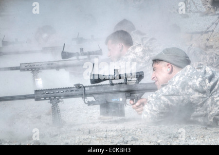 A U.S. paratrooper scans for targets behind a Barrett .50-caliber sniper  rifle while on a