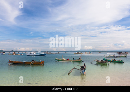 Boats and floating huts (used to grow seafood) – scenery of Ekas Bay, seen from region of Ekas, Lombok, Indonesia Stock Photo