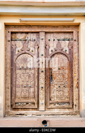 Ancient door with carving in oasis Al Haway in Oman Stock Photo
