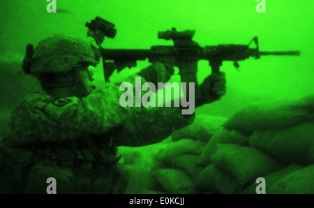 KUNAR PROVINCE, Afghanistan – Brass shells fly as U.S. Army Sgt. Joseph P. Khamvongsa of Mililani, Hawaii, a forward observer Stock Photo